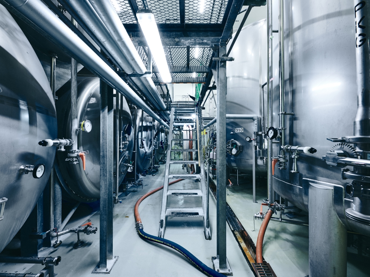 A row of fermentation tanks at Saku Brewery