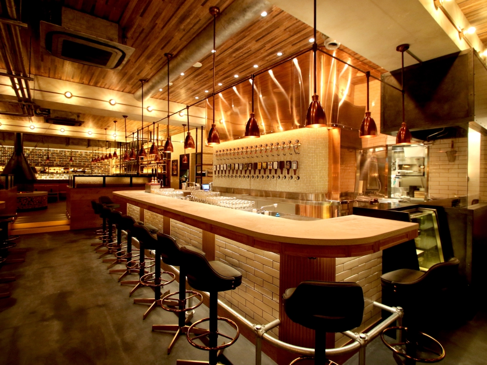 Bar counter with many taps at YONA YONA BEER WORKS Shinjuku East Exit Branch