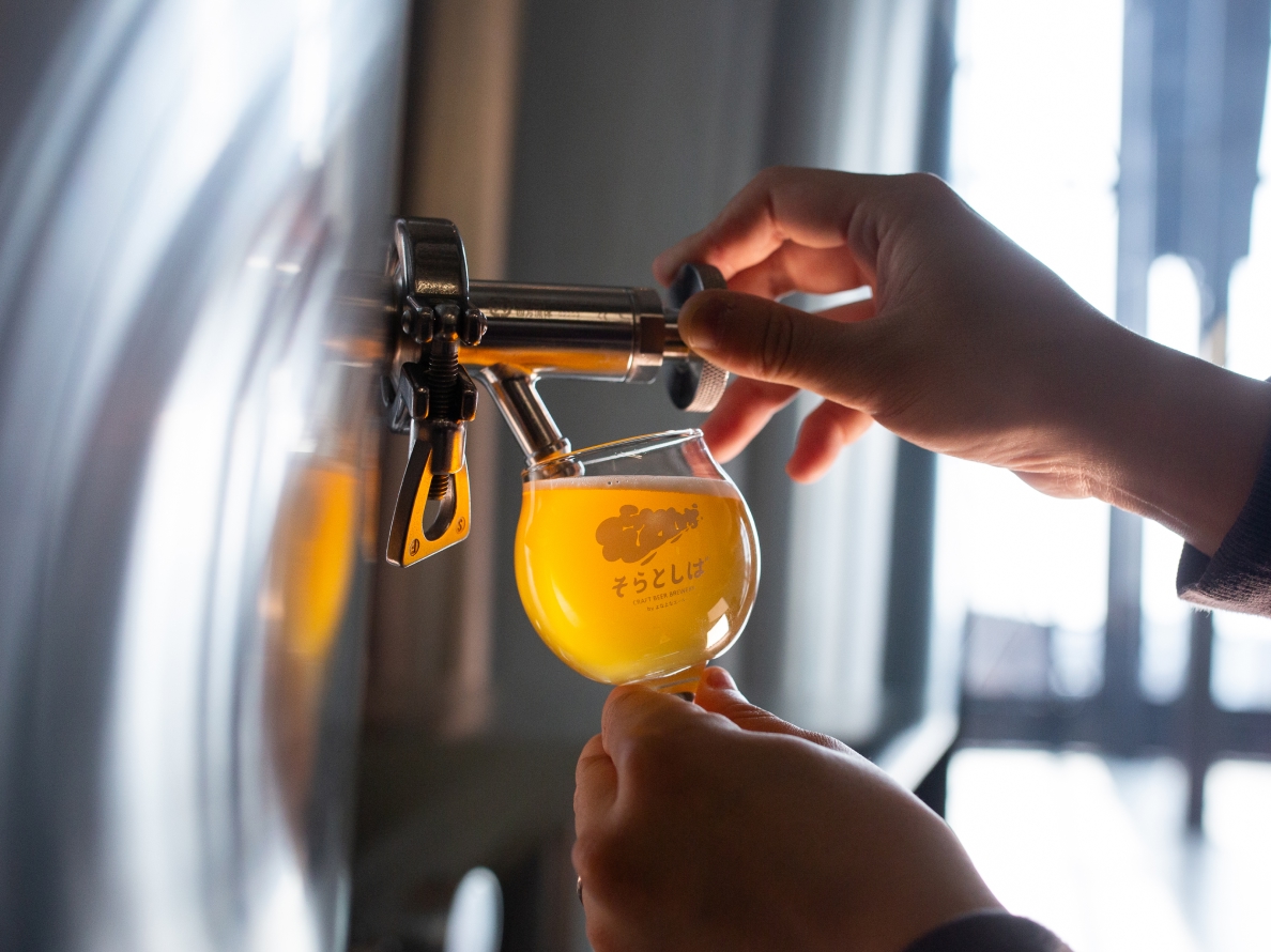 Pouring beer into a SORA TO SHIBA glass