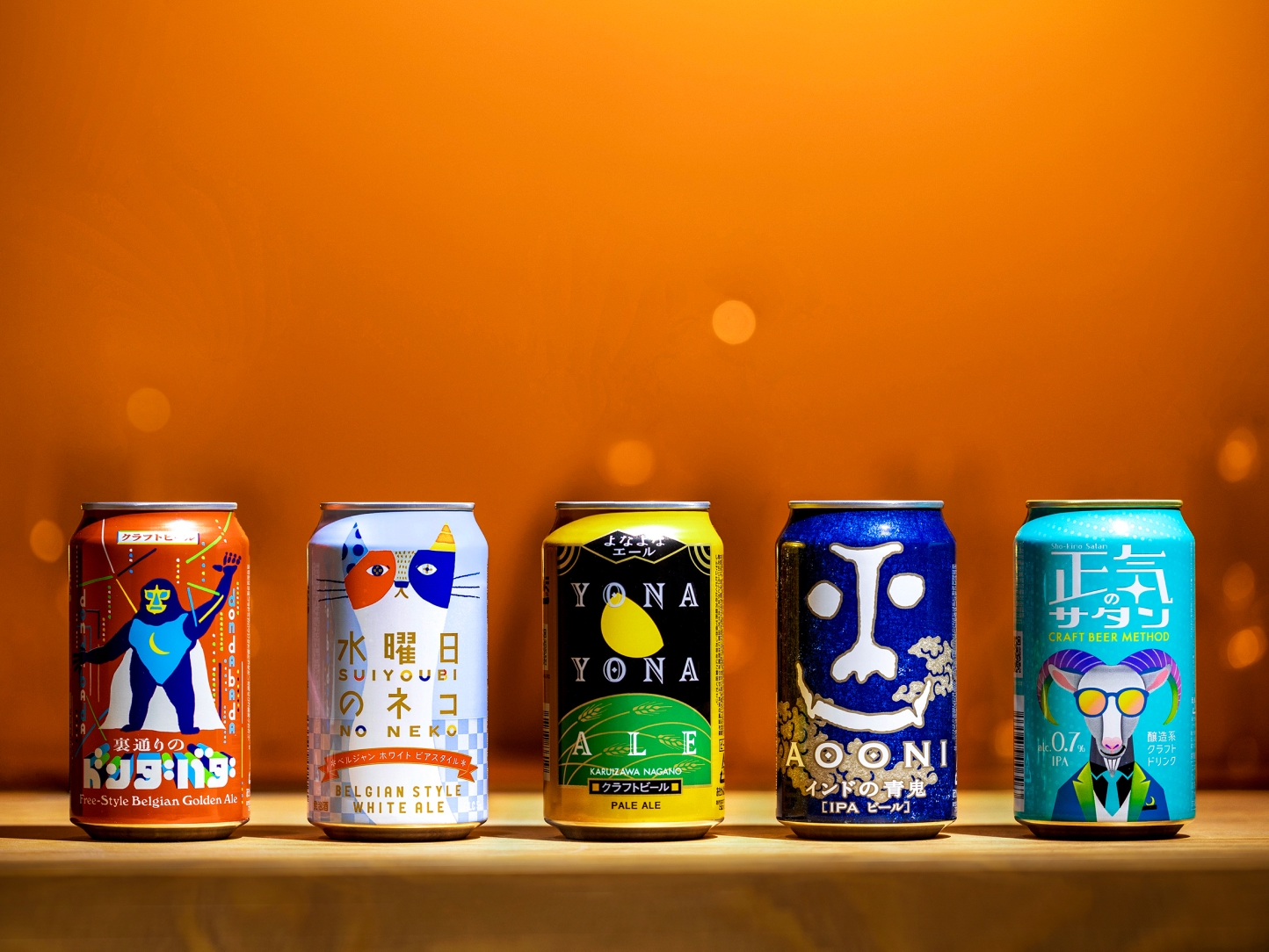 A product photo showing five types of cans lined up from left to right: 'DONDABADA', 'Wednesday Cat', 'YONA YONA ALE', 'Aooni IPA', and 'SINLESS SATAN'
